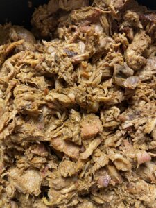 shredded and pulled pork with bucket of bread